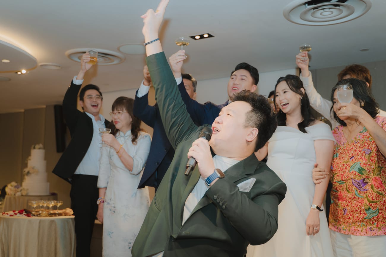 Emcee Dixon with a couple raising a toast at their wedding